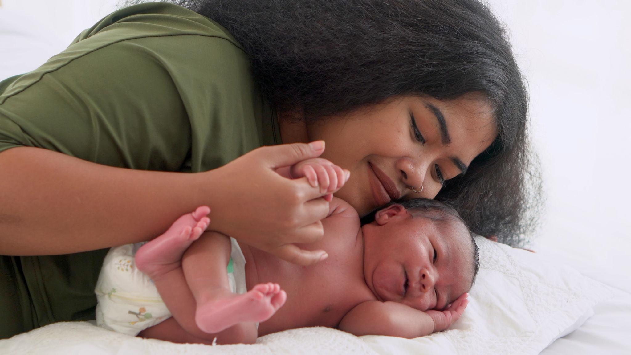 Mother holding a baby in soft natural light